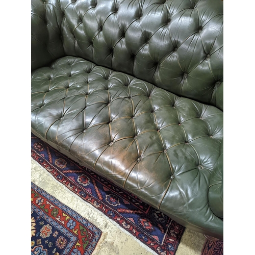 97 - A late Victorian buttoned green leather Chesterfield settee, length 184cm, depth 82cm, height 70cm... 