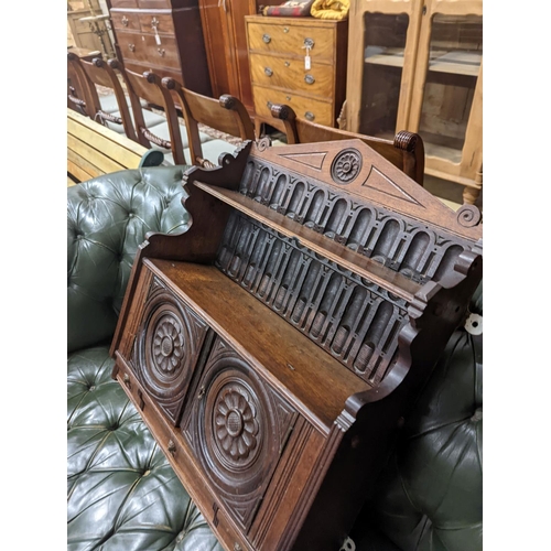 98 - A Victorian carved oak Arts and Crafts wall cabinet, width 55cm, depth 18cm, height 68cm... 