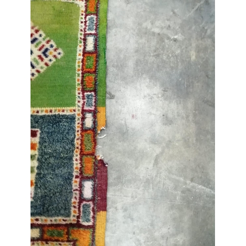 18 - A Caucasian style wool carpet, woven with polychrome geometric squares, 430 x 260cm