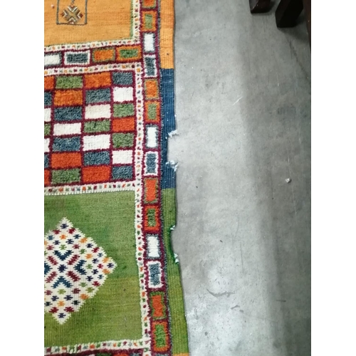 18 - A Caucasian style wool carpet, woven with polychrome geometric squares, 430 x 260cm