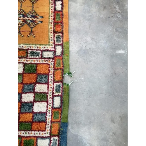 18 - A Caucasian style wool carpet, woven with polychrome geometric squares, 430 x 260cm