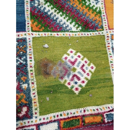 18 - A Caucasian style wool carpet, woven with polychrome geometric squares, 430 x 260cm