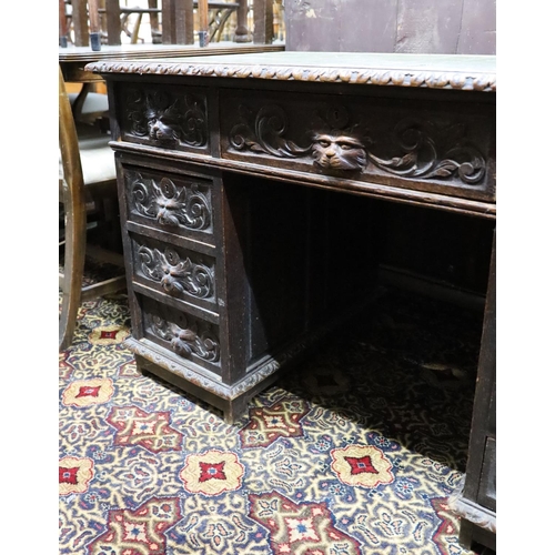 30 - A late Victorian carved oak pedestal desk, length 121cm, depth 70cm, height 75cm