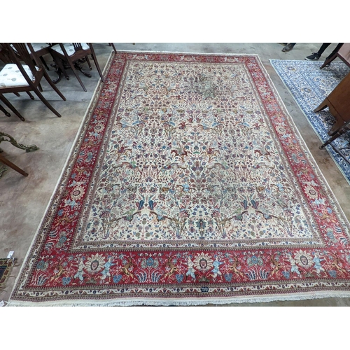 39 - A Tabriz ivory ground pictorial rug (signed), 390 x 294cm