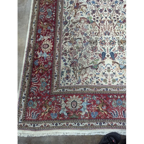39 - A Tabriz ivory ground pictorial rug (signed), 390 x 294cm