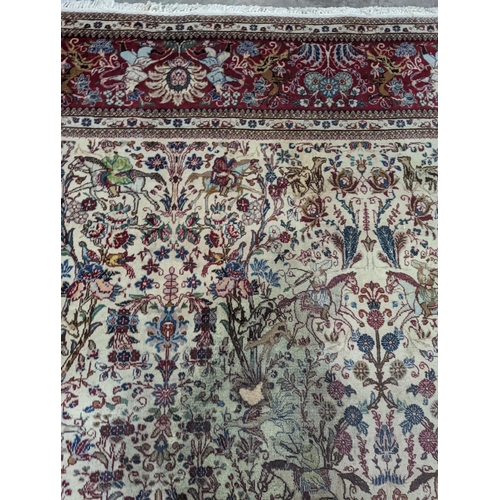 39 - A Tabriz ivory ground pictorial rug (signed), 390 x 294cm