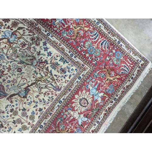 39 - A Tabriz ivory ground pictorial rug (signed), 390 x 294cm