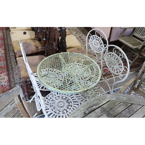 40 - A wrought iron circular garden table, diameter 65cm, height 74cm and four folding chairs... 