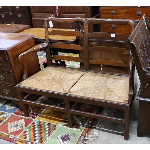 58 - A George III provincial mahogany rush seat chair back settee, length 118cm, depth 53cm, height 100cm... 