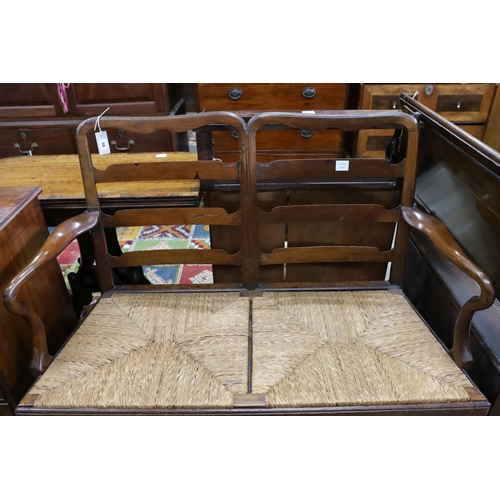 58 - A George III provincial mahogany rush seat chair back settee, length 118cm, depth 53cm, height 100cm... 