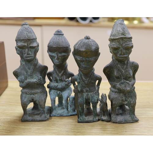 1380 - A group of Nigerian cast metal figures, bangles and a dish,  tallest 36 cms high.