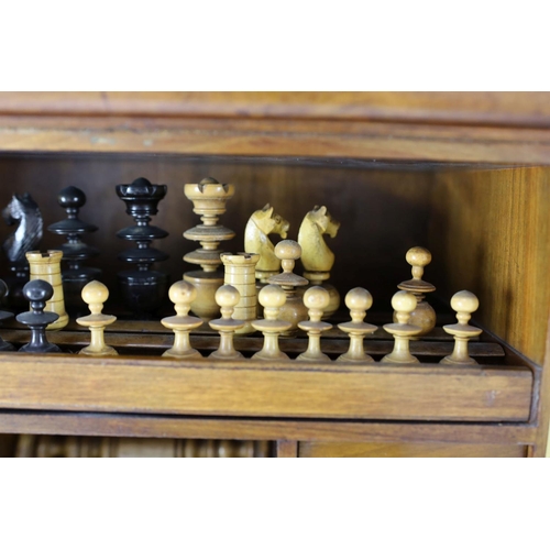 1422 - A late 19th century gilt metal mounted walnut games cabinet,with two panelled doors enclosing slidin... 