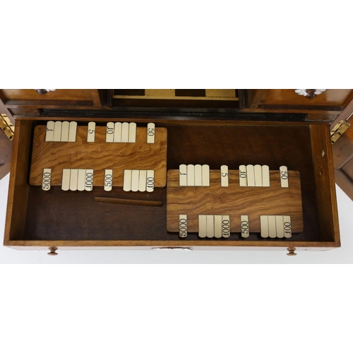 1422 - A late 19th century gilt metal mounted walnut games cabinet,with two panelled doors enclosing slidin... 