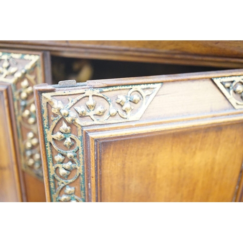 1422 - A late 19th century gilt metal mounted walnut games cabinet,with two panelled doors enclosing slidin... 