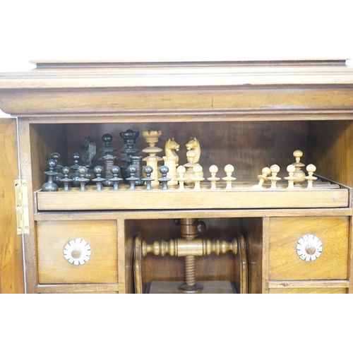 1422 - A late 19th century gilt metal mounted walnut games cabinet,with two panelled doors enclosing slidin... 