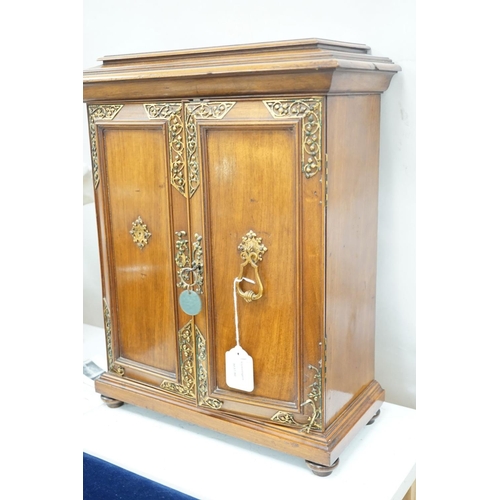 1422 - A late 19th century gilt metal mounted walnut games cabinet,with two panelled doors enclosing slidin... 