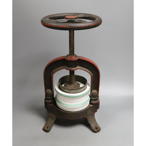 1554 - A French cast iron and ceramic pâté press, 39 cm high