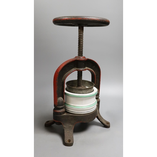 1554 - A French cast iron and ceramic pâté press, 39 cm high