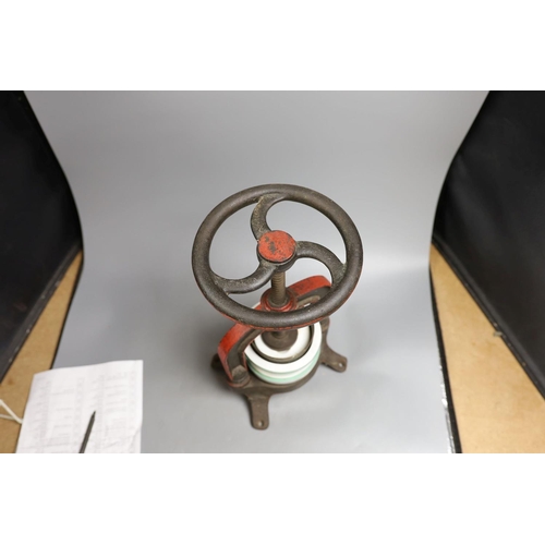1554 - A French cast iron and ceramic pâté press, 39 cm high