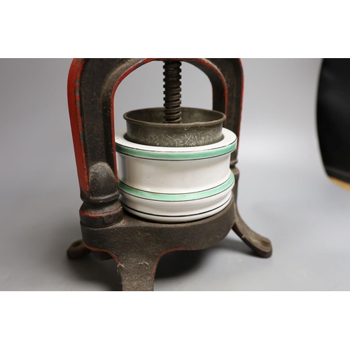 1554 - A French cast iron and ceramic pâté press, 39 cm high