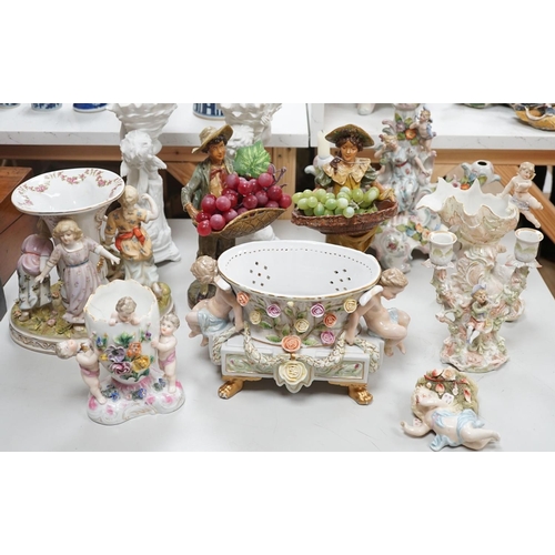 1566 - A group of Continental porcelain and pottery figural vases and centrepieces and two candelabra... 