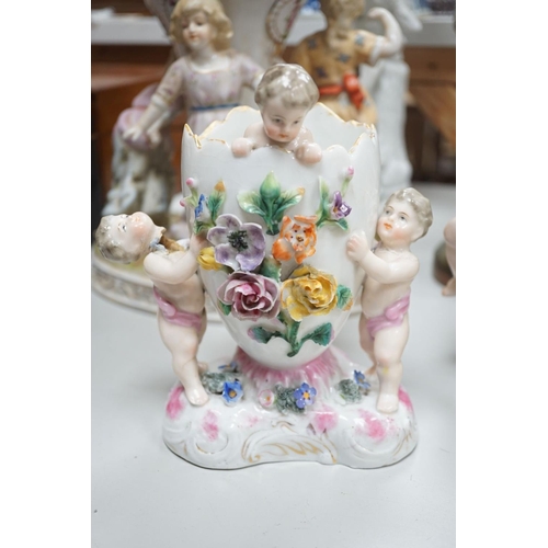 1566 - A group of Continental porcelain and pottery figural vases and centrepieces and two candelabra... 
