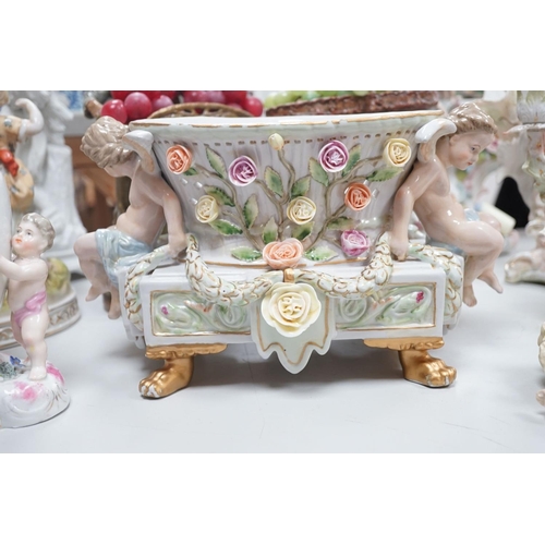 1566 - A group of Continental porcelain and pottery figural vases and centrepieces and two candelabra... 