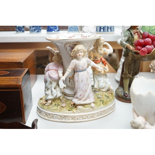 1566 - A group of Continental porcelain and pottery figural vases and centrepieces and two candelabra... 