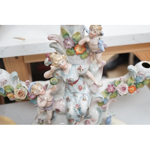 1566 - A group of Continental porcelain and pottery figural vases and centrepieces and two candelabra... 