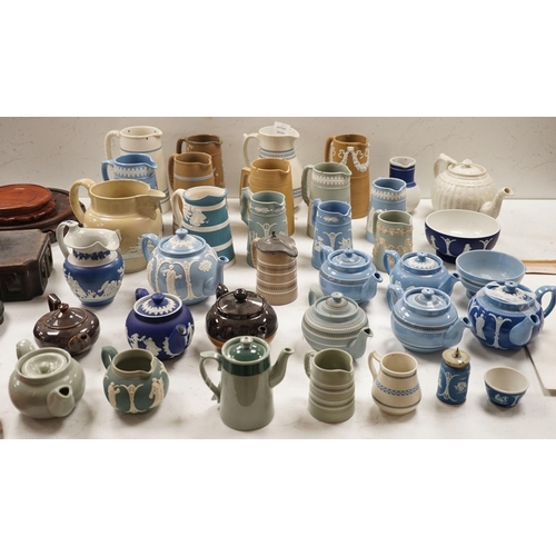 1576 - A collection of Dudson stoneware, including jugs, teapots, cream jugs etc, many decorated in low rel... 