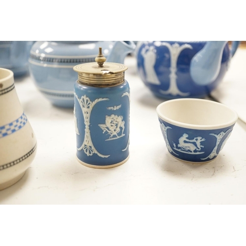 1576 - A collection of Dudson stoneware, including jugs, teapots, cream jugs etc, many decorated in low rel... 