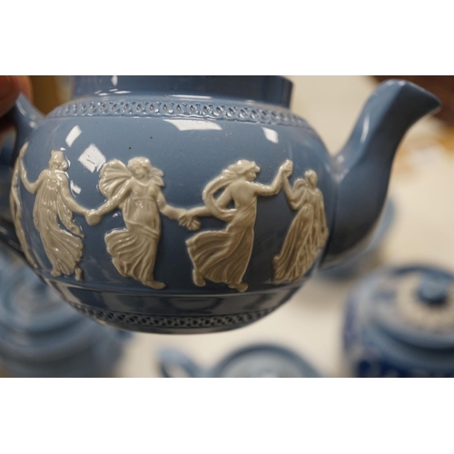 1576 - A collection of Dudson stoneware, including jugs, teapots, cream jugs etc, many decorated in low rel... 