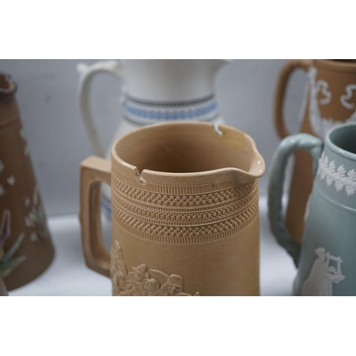 1576 - A collection of Dudson stoneware, including jugs, teapots, cream jugs etc, many decorated in low rel... 