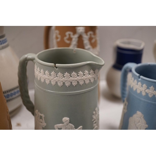 1576 - A collection of Dudson stoneware, including jugs, teapots, cream jugs etc, many decorated in low rel... 