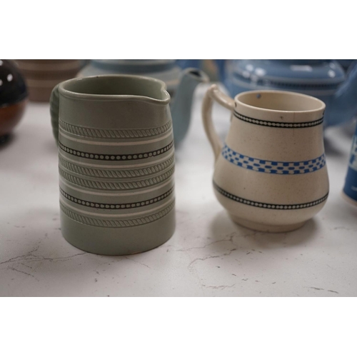1576 - A collection of Dudson stoneware, including jugs, teapots, cream jugs etc, many decorated in low rel... 