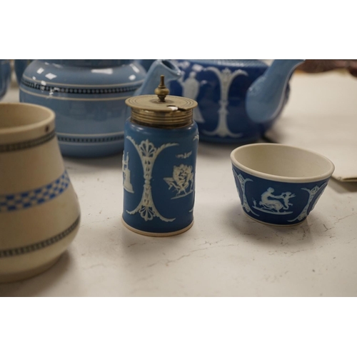 1576 - A collection of Dudson stoneware, including jugs, teapots, cream jugs etc, many decorated in low rel... 