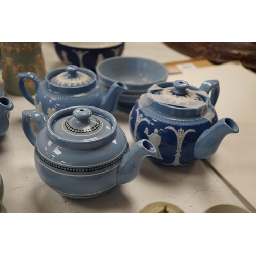 1576 - A collection of Dudson stoneware, including jugs, teapots, cream jugs etc, many decorated in low rel... 