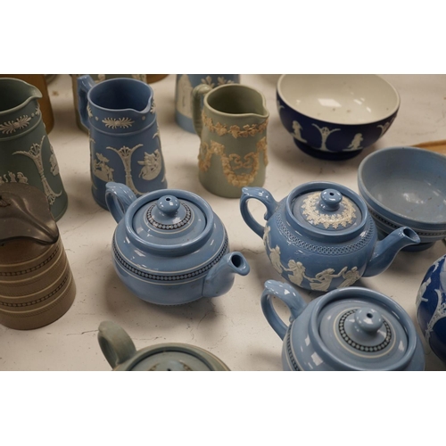 1576 - A collection of Dudson stoneware, including jugs, teapots, cream jugs etc, many decorated in low rel... 