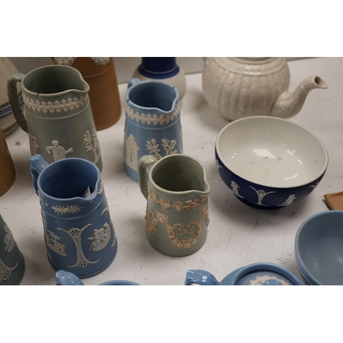 1576 - A collection of Dudson stoneware, including jugs, teapots, cream jugs etc, many decorated in low rel... 