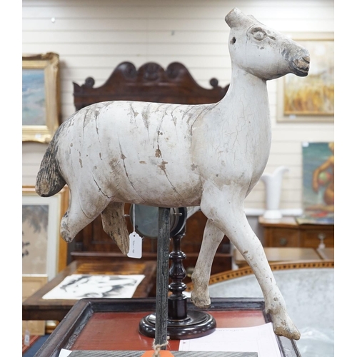 1590 - A carved and painted wood model of a goat, with distressed paint, on stand. 66cm