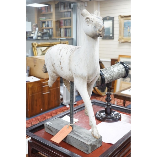 1590 - A carved and painted wood model of a goat, with distressed paint, on stand. 66cm