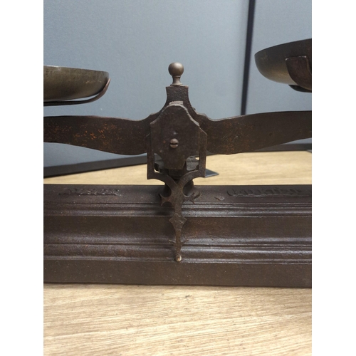 1557 - A large French cast iron and brass weighing scale,82 cms wide.