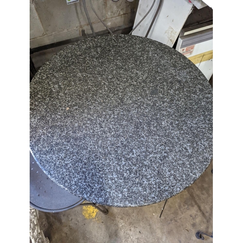 1004 - A circular stone top garden table, diameter 75cm, height 72cm and two chairs