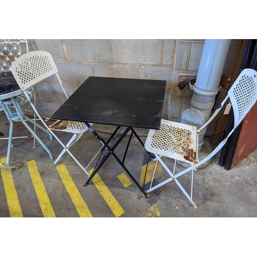 1010 - A square metal folding bistro table, width 60cm, height 71cm, together with two metal chairs... 