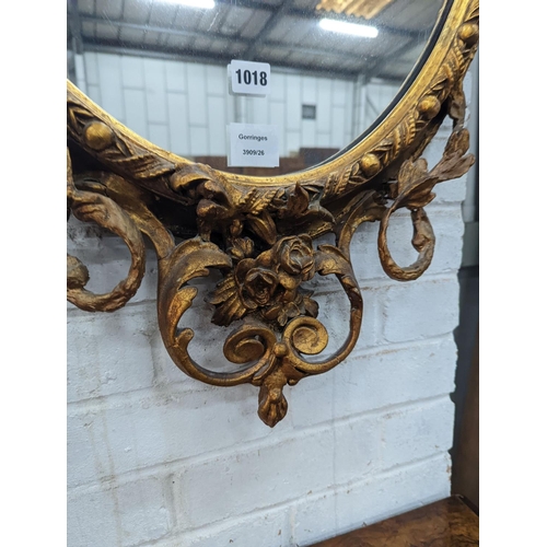 1018 - A late Victorian giltwood and gesso oval framed wall mirror, width 54cm, height 100cm