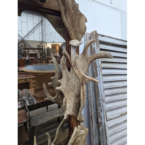 1030 - A rectangular moose antler wall mirror, width 132cm, height 80cm