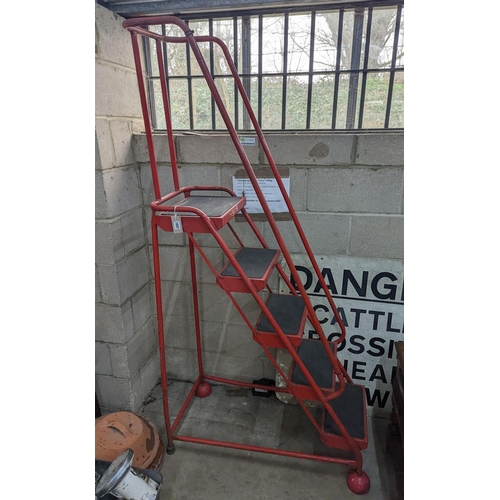 1037 - A set of red painted metal steps, height 188cm