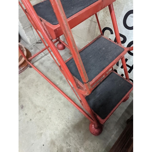 1037 - A set of red painted metal steps, height 188cm