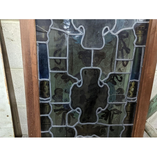 1039 - A rectangular stained glass panel, width 56cm, height 99cm including frame