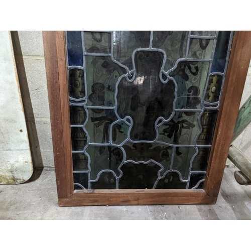 1039 - A rectangular stained glass panel, width 56cm, height 99cm including frame